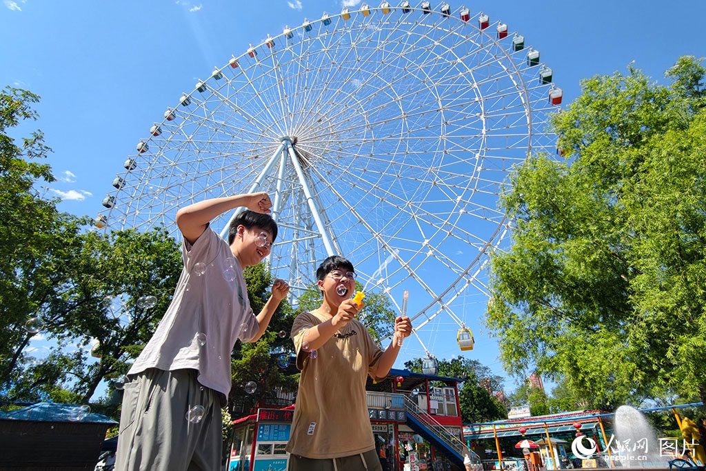 2026年5月30日,在遼寧沈陽(yáng)萬(wàn)泉公園,孩子們正在88米高的摩天輪下快樂(lè)地玩耍。人民網(wǎng)記者 周頌雪攝 2026年5月30日,在遼寧沈陽(yáng)萬(wàn)泉公園,孩子們正在88米高的摩天輪下快樂(lè)地玩耍。人民網(wǎng)記者 周頌雪攝
